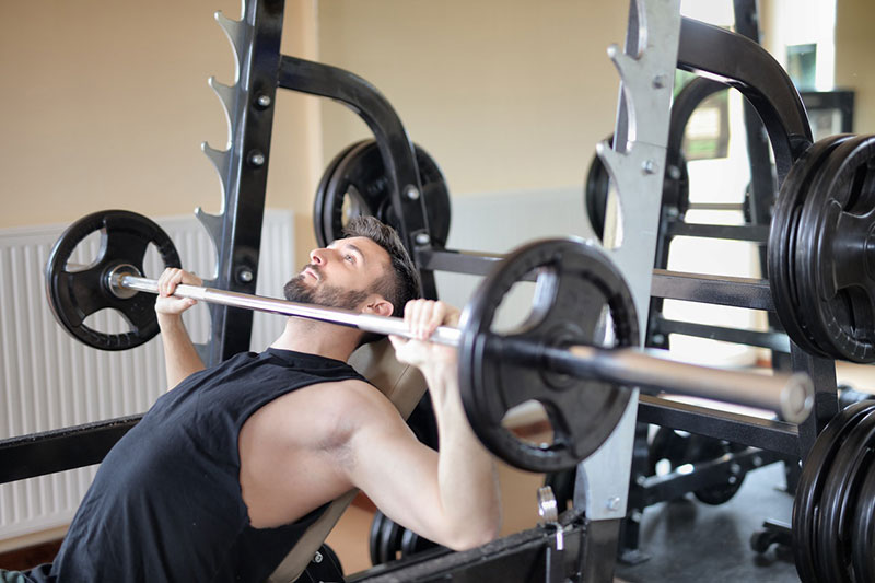 a person lifting weights at a gym 