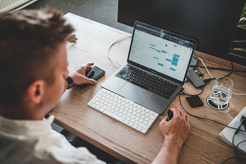 a person using an online scheduling system on a laptop 