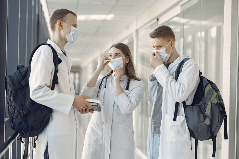 three medical workers in a clinic