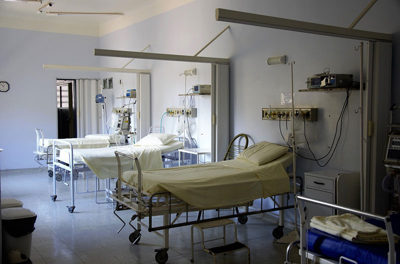 a hospital room with empty beds